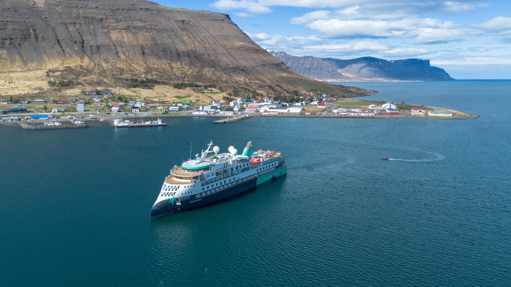 An aerial view of ship sailing in Iceland's Westfjords. 