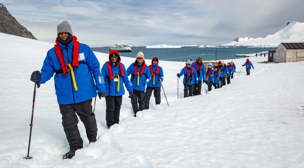 Guests hiking on shore in Antarctica. 