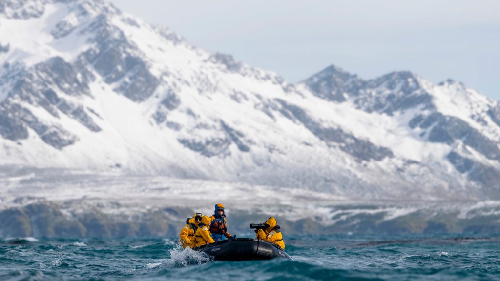 Guest riding in zodiac in choppy waters.