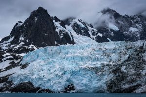 Glaicer flowing down from rugged peaks in South Georgia. 